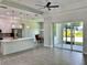 Open kitchen with white cabinets and island at 23466 Garrett Ave, Port Charlotte, FL 33954