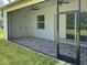 Spacious screened patio with paver tile floor and ceiling fan at 23466 Garrett Ave, Port Charlotte, FL 33954