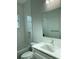 Clean bathroom featuring a quartz vanity and white tile at 23466 Garrett Ave, Port Charlotte, FL 33954