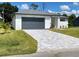 Modern one-story home with gray garage door and gray trim at 23466 Garrett Ave, Port Charlotte, FL 33954