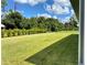 Large backyard with grassy lawn and lush landscaping at 23466 Garrett Ave, Port Charlotte, FL 33954