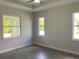 Bright bedroom with large windows and ceiling fan at 23466 Garrett Ave, Port Charlotte, FL 33954