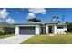 Modern one-story home with gray garage door and gray trim at 23466 Garrett Ave, Port Charlotte, FL 33954