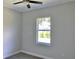 Cozy bedroom with a single window and wood-look floors at 23466 Garrett Ave, Port Charlotte, FL 33954