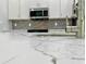Close-up of kitchen countertop with quartz waterfall edge and modern faucet at 23466 Garrett Ave, Port Charlotte, FL 33954