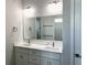 Elegant bathroom with double vanity, quartz countertop and large mirror at 23466 Garrett Ave, Port Charlotte, FL 33954