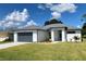 Modern one-story home with gray garage door and gray trim at 23466 Garrett Ave, Port Charlotte, FL 33954