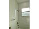 Modern bathroom with white tile and a built-in bathtub at 23466 Garrett Ave, Port Charlotte, FL 33954