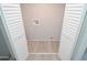 Small laundry room with white louvered doors and vinyl flooring at 2852 60Th N Ave, St Petersburg, FL 33714