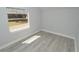 Simple bedroom with gray walls, wood-look flooring, and a window with backyard view at 2852 60Th N Ave, St Petersburg, FL 33714