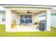 Relaxing covered patio with seating and grill at 11519 Misty Isle Ln, Riverview, FL 33579