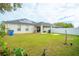 Spacious backyard with covered patio, solar panels, and grassy area at 11519 Misty Isle Ln, Riverview, FL 33579