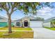 Tan one-story home with two-car garage at 11519 Misty Isle Ln, Riverview, FL 33579