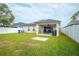 Large backyard with covered patio and grassy area at 11519 Misty Isle Ln, Riverview, FL 33579