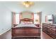 Main bedroom with wood furniture and large windows at 11519 Misty Isle Ln, Riverview, FL 33579