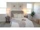 Bright bedroom featuring a cozy bed with decorative pillows and stylish decor, complemented by natural light from two windows at 232 Vistera Blvd, Nokomis, FL 34275