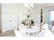 Chic dining room with a round table, elegant chairs, and a modern chandelier at 232 Vistera Blvd, Nokomis, FL 34275