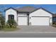 Charming single-story home featuring a two-car garage, stone accents, and a well-manicured front yard at 232 Vistera Blvd, Nokomis, FL 34275