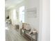 Inviting hallway with natural light, stylish bench seating and contemporary artwork at 232 Vistera Blvd, Nokomis, FL 34275