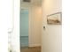 Hallway with light wood floors and neutral wall art at 232 Vistera Blvd, Nokomis, FL 34275