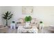 Bright living room with neutral tones, modern art, and decorative plants at 232 Vistera Blvd, Nokomis, FL 34275