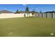 Grassy backyard enclosed by a white fence, providing a private outdoor space for relaxation and recreation at 3522 N Maryland Ave, Plant City, FL 33565