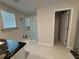 Modern bathroom featuring a glass-enclosed shower, granite countertops, and neutral tile flooring at 3522 N Maryland Ave, Plant City, FL 33565