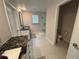 Bright bathroom with double vanities, granite counters, walk-in shower, and separate toilet area at 3522 N Maryland Ave, Plant City, FL 33565