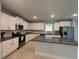 Well-lit kitchen features granite countertops, stainless appliances, and white cabinets at 3522 N Maryland Ave, Plant City, FL 33565