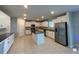 A modern kitchen featuring white cabinets, stainless steel appliances, and a center island at 3522 N Maryland Ave, Plant City, FL 33565