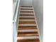 Staircase featuring wood treads and white risers ascends to the upper level at 3522 N Maryland Ave, Plant City, FL 33565