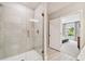 Modern bathroom featuring glass enclosed shower with white tiling and access to main bedroom at 5213 Patano Loop, Palmetto, FL 34221