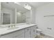 Modern bathroom with double vanity, quartz countertops, and a glass-enclosed shower and separate toilet at 5213 Patano Loop, Palmetto, FL 34221