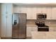 Modern kitchen featuring stainless steel appliances and white cabinetry at 14071 Heritage Landing Blvd # 334, Punta Gorda, FL 33955
