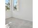 Well-lit bedroom with carpet floors and two windows at 18011 Cherished Loop, Bradenton, FL 34211