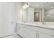 Double vanity bathroom with white cabinets and marble countertops at 18019 Cherished Loop, Bradenton, FL 34211