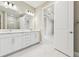 Double vanity bathroom with white cabinets and marble counters at 18019 Cherished Loop, Bradenton, FL 34211