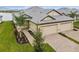 Two-car garage, double-wide driveway, and attractive landscaping at 18019 Cherished Loop, Bradenton, FL 34211