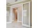 Bright hallway with glass doors and white flooring at 18019 Cherished Loop, Bradenton, FL 34211