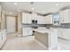 Modern kitchen featuring white cabinets and a large island at 18019 Cherished Loop, Bradenton, FL 34211