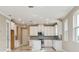 Modern kitchen with white cabinets, breakfast bar, and tile floors at 18019 Cherished Loop, Bradenton, FL 34211