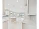 Open concept kitchen with a large island and white cabinets at 18019 Cherished Loop, Bradenton, FL 34211