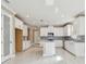 Bright kitchen, island, white cabinets, and stainless steel appliances at 18019 Cherished Loop, Bradenton, FL 34211