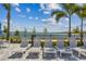 Relaxing poolside lounge chairs overlooking a lake at 1925 Transom Ln, Sarasota, FL 34240