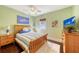 Bedroom with wood flooring, ceiling fan, and wooden bed frame at 322 Buena Vista Ave, Sarasota, FL 34243