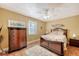 Cozy bedroom with a dark wood bed frame, dresser, and terracotta tile floors at 322 Buena Vista Ave, Sarasota, FL 34243