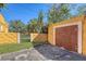 Detached garage with wooden doors and a concrete driveway at 322 Buena Vista Ave, Sarasota, FL 34243