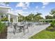 Seating area with tables and chairs near the community pool at 338 Via Anina Dr, Sarasota, FL 34243