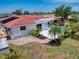 Aerial backyard view of a house with pool, patio, and lush landscaping at 416 Gulf Breeze Blvd, Venice, FL 34293