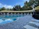 Resort-style pool with ample lounge chairs at 4247 Bramblewood Loop, Spring Hill, FL 34609